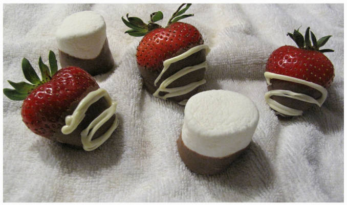 Strawberries and marshmallows covered in chocolate Strawberries and marshmallows covered in chocolate