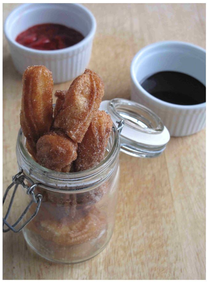 Cinnamon-sugar churros with strawberry and chocolate dipping sauces Cinnamon-sugar churros with strawberry and chocolate dipping sauces