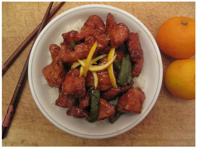 Sweet and sour orange chicken with green peppers, rice, and orange zest.