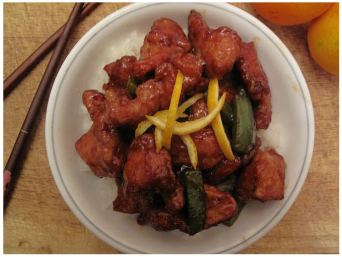 Sweet and sour orange chicken with green peppers, rice, and orange zest.