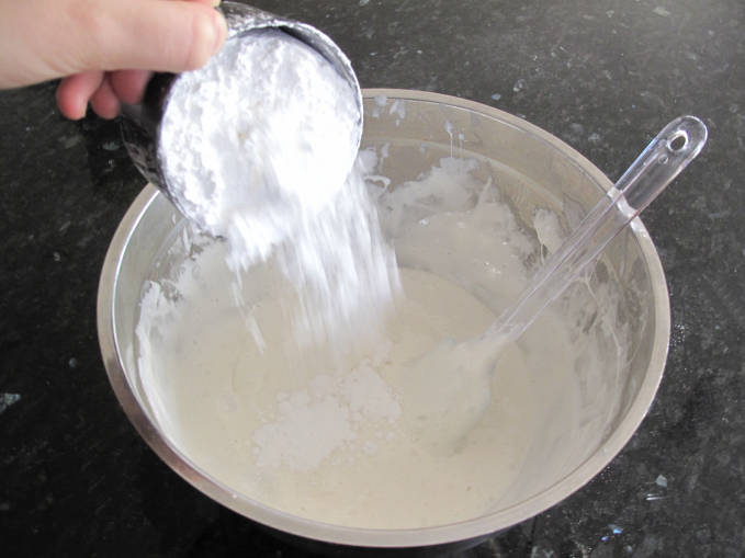 Adding icing sugar to melted marshmallows to make fondant
