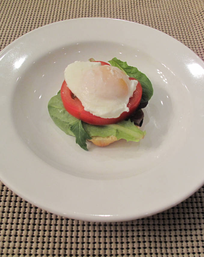 Poached egg with vegetables and a homemade English muffin.