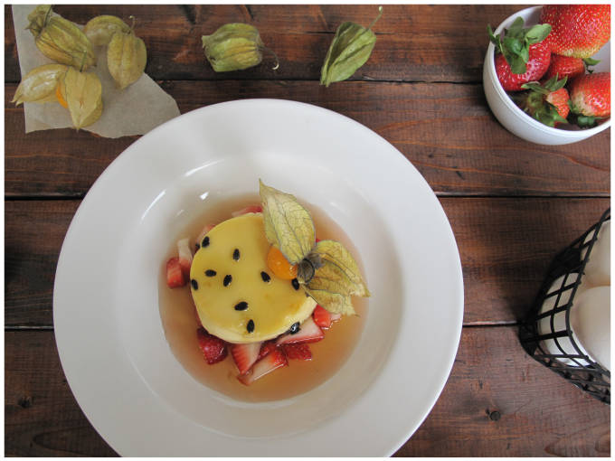 Passion fruit crème caramel with strawberries and a Chinese lantern fruit