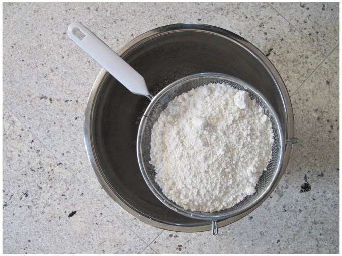 Sifting powdered sugar and almonds