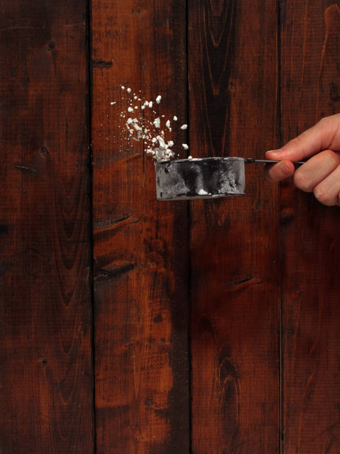 Flour being tossed up in a cup