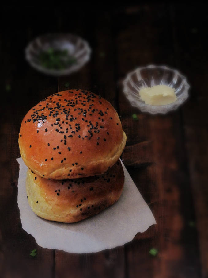 Homemade challah hamburger buns with butter and chives