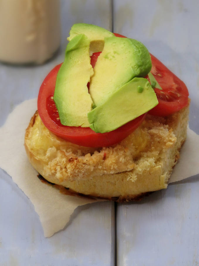 Homemade challah bun with chicken, cheese, tomato, and avocado