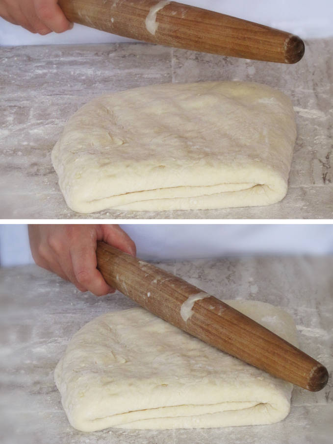 Hitting the croissant dough with a rolling pin to distribute the beurrage (butter and flour block)