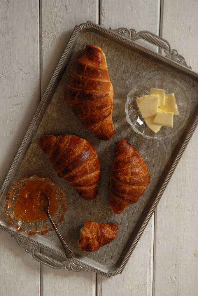 Homemade croissants with apricot jam and butter