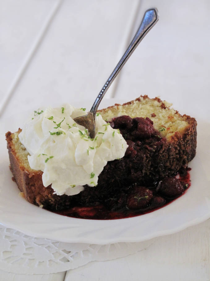 Coconut bread with lime-raspberry compote and freshly whipped cream topped with lime zest