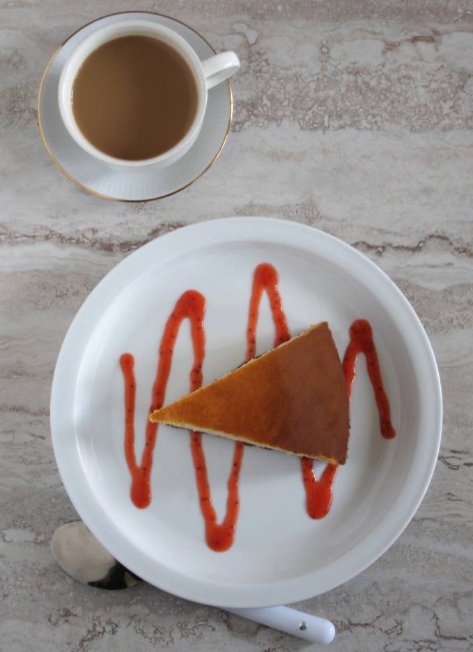 New York vanilla cheesecake with strawberry sauce and coffee