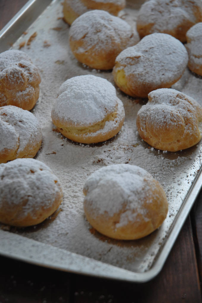 Profiteroles covered with powdered sugar