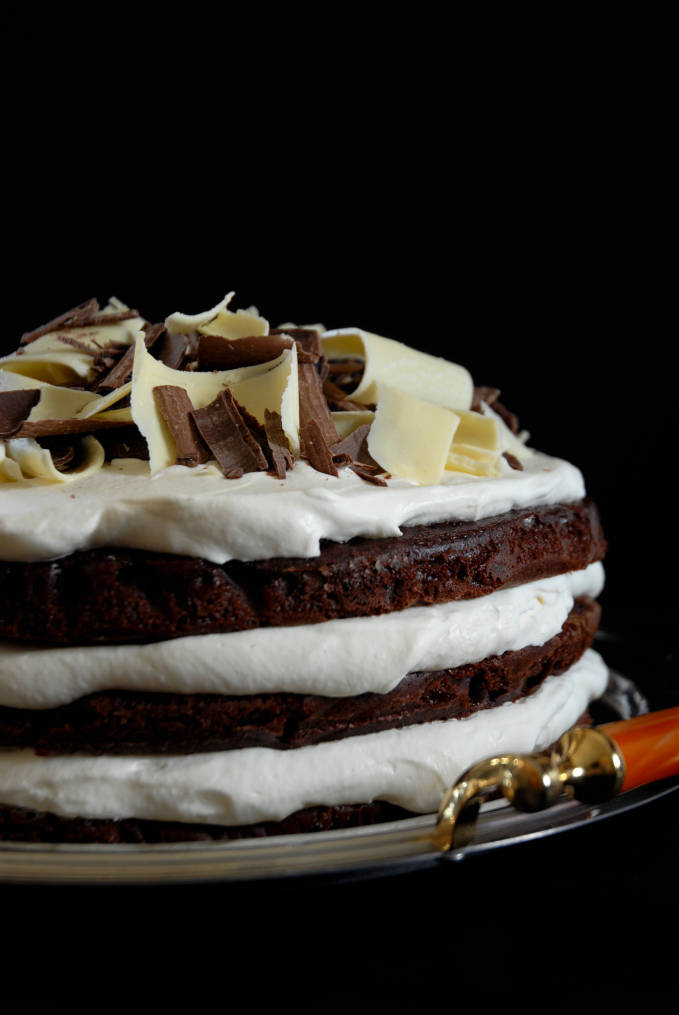 Chocolate cake with spiked whipped cream and chocolate curls. Click for the recipe!