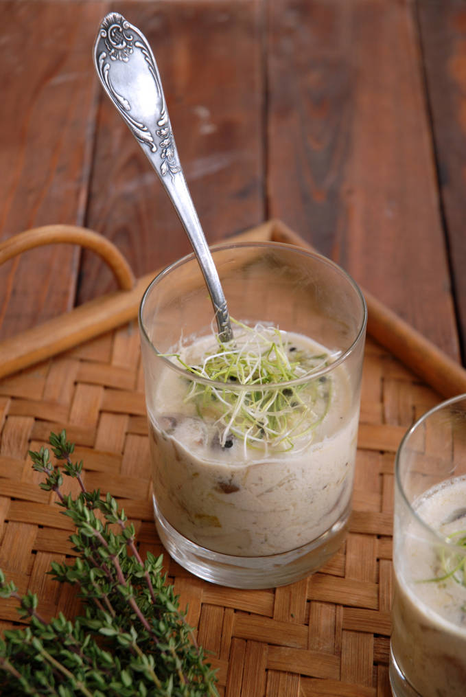 Cream of mushroom soup with leeks and cremini mushrooms, topped with baby onion sprouts. Click to get the MOST AMAZING recipe for cream of mushroom soup!