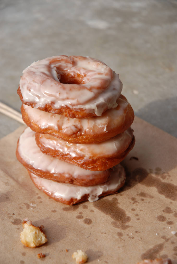 A stack of vanilla doughnuts. Click to get the AMAZING recipe so you can make them yourself at home.