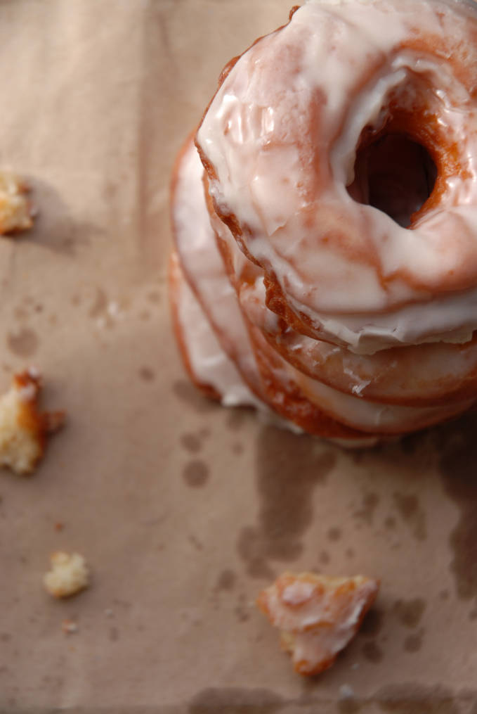 A top view of a stack of vanilla donuts. Click to get the AMAZING recipe so you can make them yourself at home.