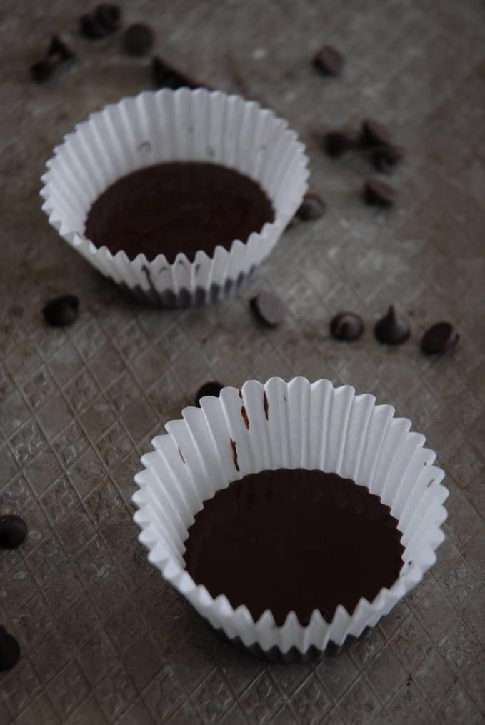 Adding chocolate to homemade Reese's peanut butter cups. Make your own! Click for the recipe.