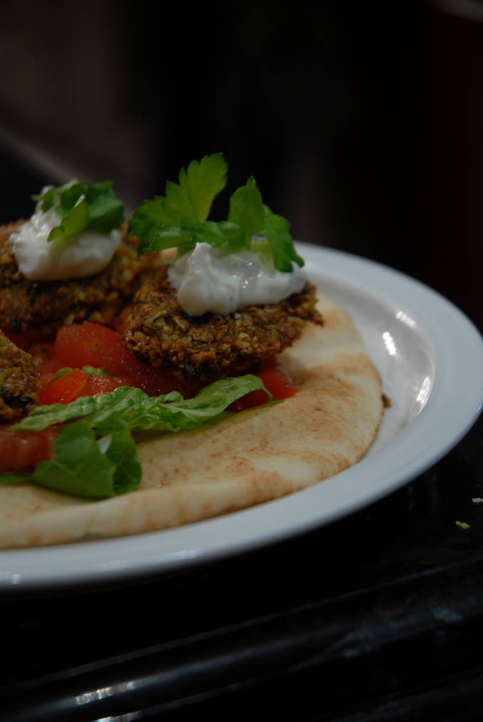 Homemade chickpea falafel on a pita with lettuce, tomato, onion, and tzatziki sauce... click for the recipe!