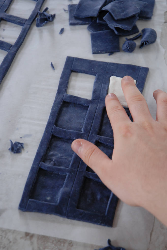 Adding a fondant window to a Doctor Who TARDIS cake--click to see the full photo tutorial so YOU CAN MAKE YOUR OWN DOCTOR WHO TARDIS CAKE! #diy