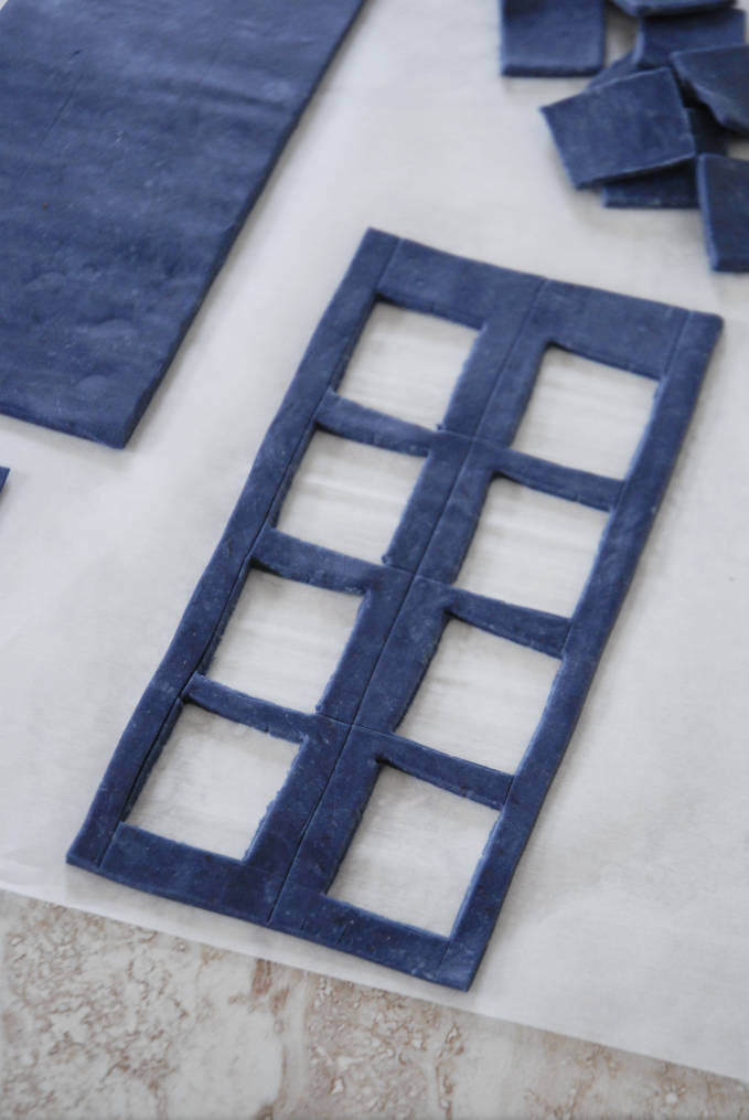 Cutting out panels from TARDIS cake sides--click to see the full photo tutorial so YOU CAN MAKE YOUR OWN DOCTOR WHO TARDIS CAKE! #diy