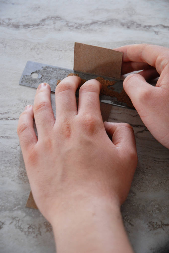 Forming a cardboard cutter to cut out TARDIS panels--click to see the full photo tutorial so YOU CAN MAKE YOUR OWN DOCTOR WHO TARDIS CAKE! #diy