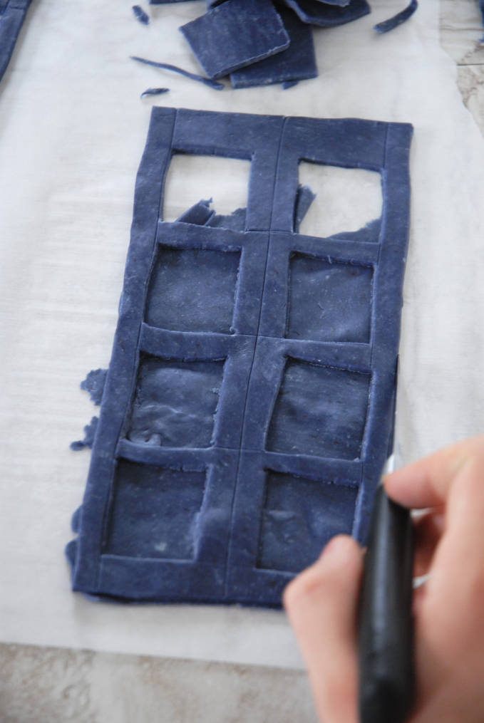 Trimming edges of Doctor Who TARDIS cake sides--click to see the full photo tutorial so YOU CAN MAKE YOUR OWN DOCTOR WHO TARDIS CAKE! #diy