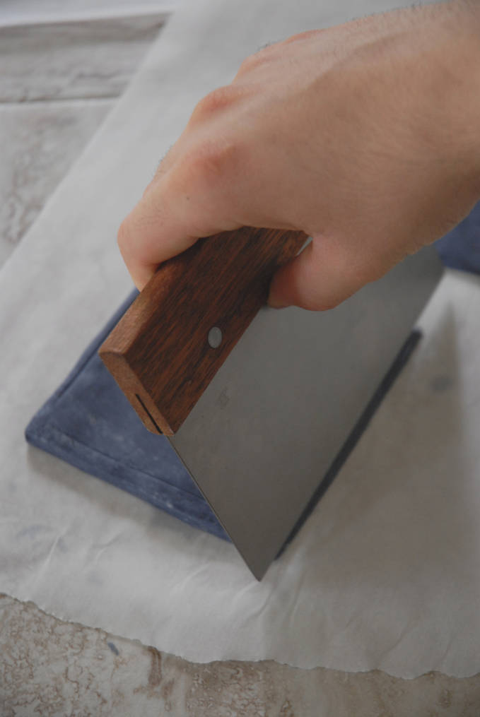 Cutting slanted edges on base of TARDIS cake--click to see the full photo tutorial so YOU CAN MAKE YOUR OWN DOCTOR WHO TARDIS CAKE! #diy