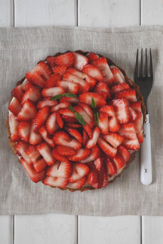 Strawberry tart with vanilla pastry cream, white chocolate, and a lemon glaze--click to get instructions on how to make PERFECT PIE & TART DOUGH every time!