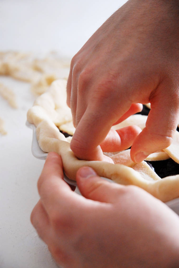 Crimping pie dough helps keep it together while baking--click to get a step-by-step photo tutorial on lattice pie crusts, so you can make them easily!