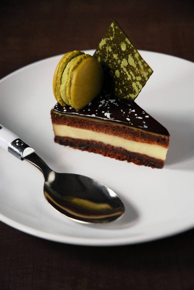 Chocolate and matcha entremet with a chewy dark chocolate brownie layer, vanilla crémeux, chocolate joconde cake, a thin layer of matcha mousse, chocolate mirror glaze, and a matcha macaron. Click for the recipe!