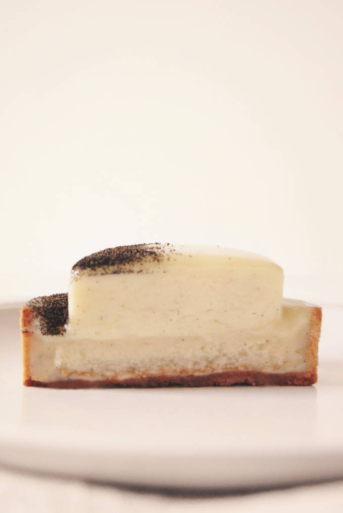 Do you like vanilla? This is a vanilla tart with white chocolate-vanilla ganache, rum-infused lady finger biscuit, vanilla mascarpone cream, and ground vanilla bean garnish!