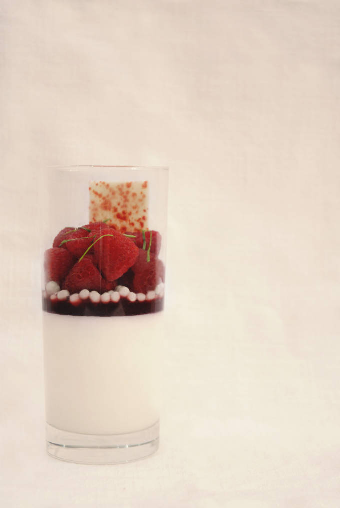 Raspberry and Greek yogurt panna cotta with crispy white chocolate pearls, fresh raspberry gel, juicy raspberries, and a white chocolate decoration. You won't believe how easy it is to make... click to get the recipe!
