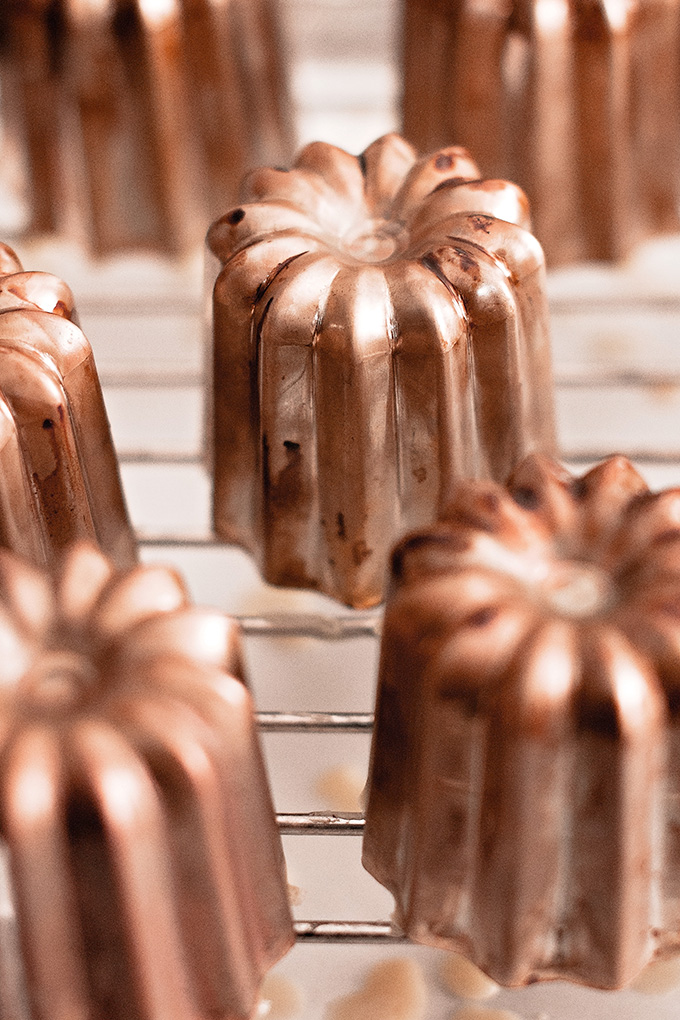 Upside down canelé moulds to allow white oil to drip out
