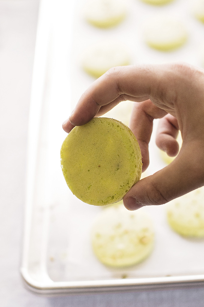 A very lightly browned French macaron shell is ready